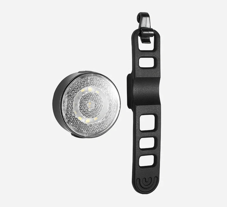 Bicycle LED headlight with clip attachment showing lens reflectors and USB port for charging