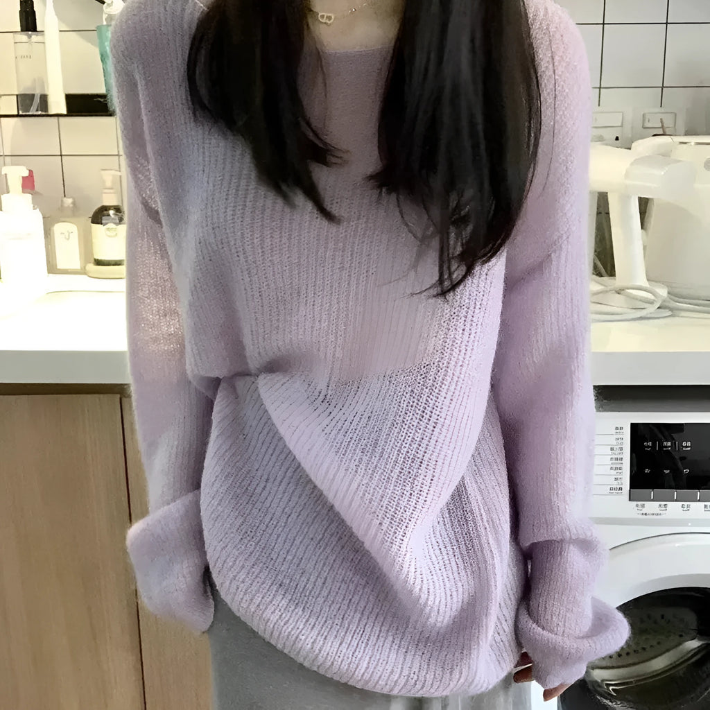 Purple women's sleeveless blouse with hollow out detail and princess sleeves, laid flat.