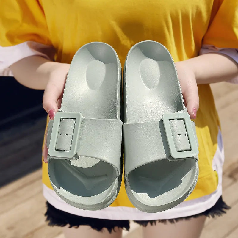 Women's grey blue buckle slipper with adjustable strap and soft EVA sole.