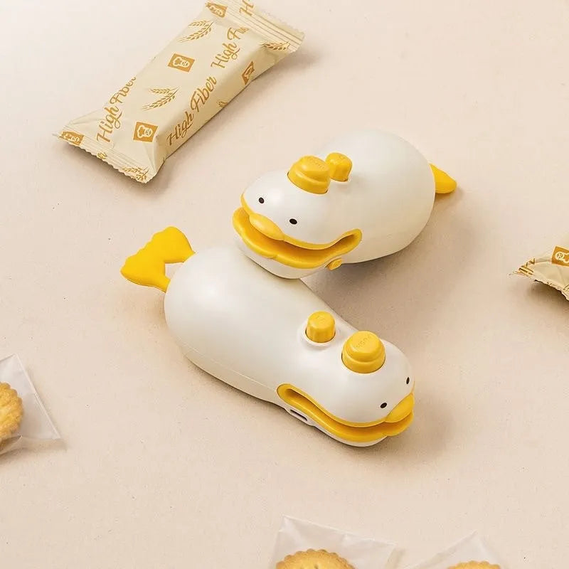 Small Yellow Duck shaped rechargeable bag sealer with animal jacquard pattern and USB cable.
