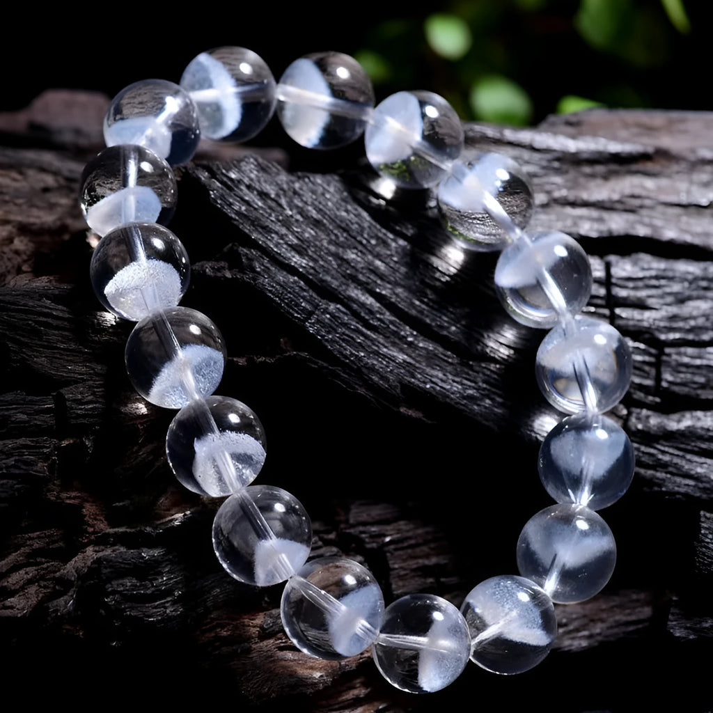 Women's adjustable white crystal bracelet with a pyramid bead and ruyi charm, shown on a wrist.