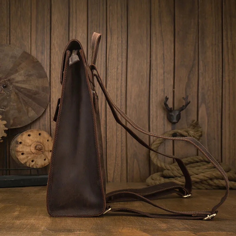 Dark brown genuine leather men's travel bag with retro style, showing three-dimensional pockets and shoulder straps.