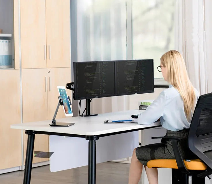 Silver aluminium foldable desktop stand holding a tablet, showing 360-degree rotation.