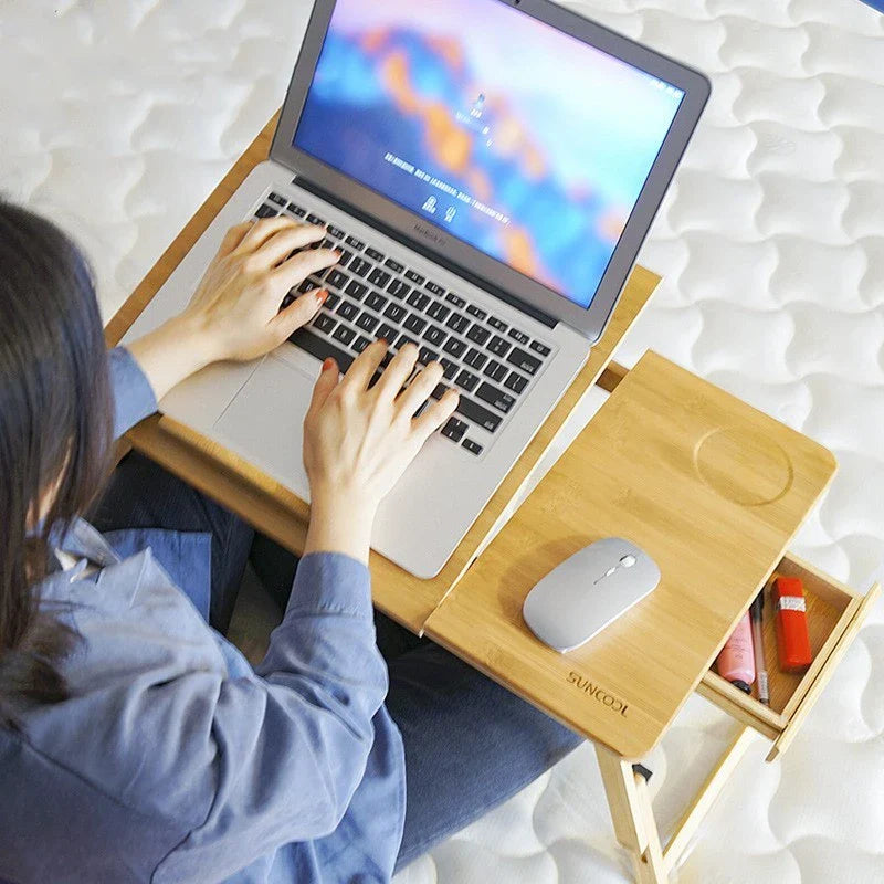 Foldable laptop bed desk with storage drawers and small fan, made from natural bamboo
