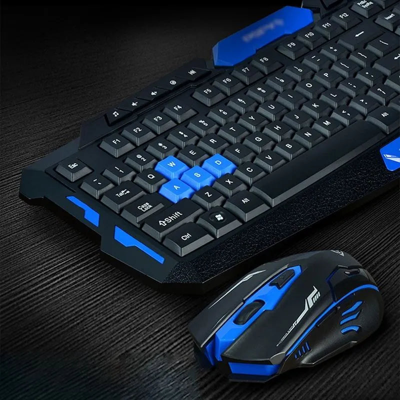 Blue and black wireless keyboard and mouse set on a desk, showing the low-profile keyboard and ergonomic mouse.