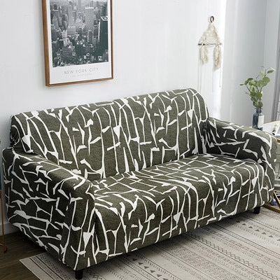 Printed stretchable sofa slipcover covering a three-seater sofa in a modern geometric pattern