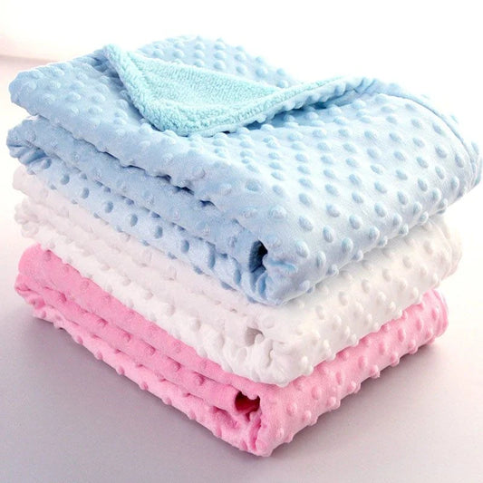 Soft and cozy baby blanket in various colors, including white, blue, gray, purple, green, and pink, with a plush, short-pile fabric and luxurious lamb velvet backing