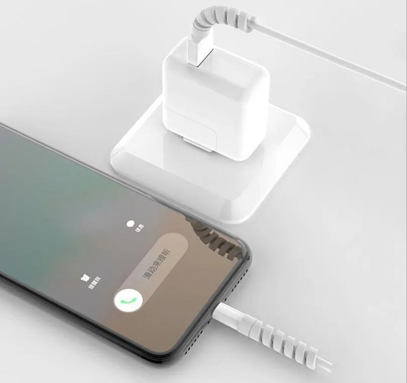 Close-up of a black rigid plastic charging cable protector next to a smartphone charging cable.