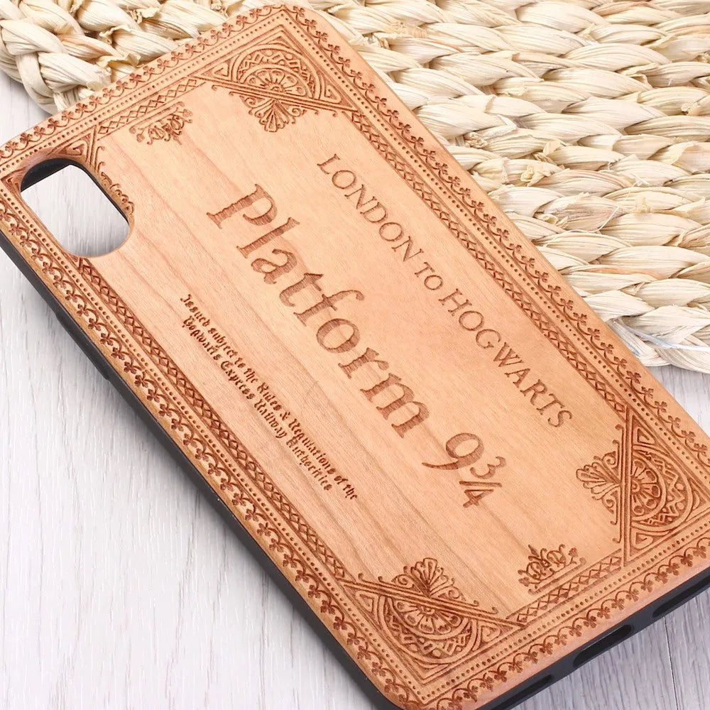 Wooden iPhone case with laser-carved floral design and black TPU bumper on a rosewood back.