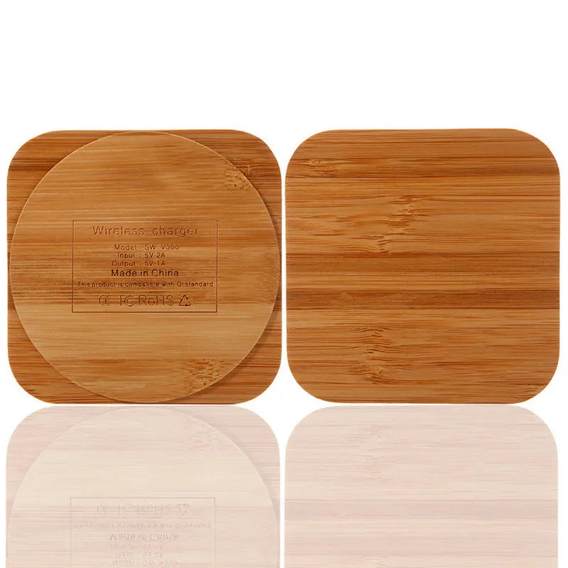 Square natural bamboo 5W QI wireless charging pad on a wooden surface.