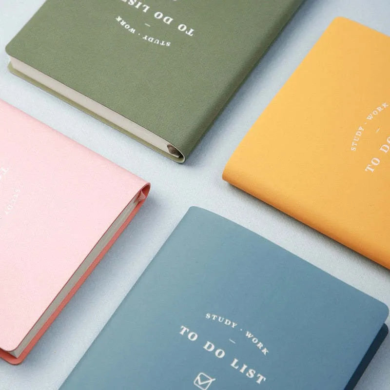 Simple Style 48K PU cover todolist notebook open on a desk, showing Macaron Yellow colour and lined writing paper.