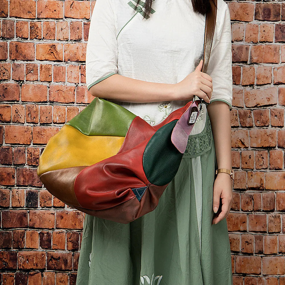 Brown cowhide leather crossbody travel bag showing front and side view