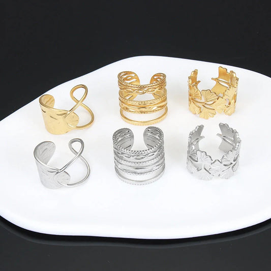 Adjustable stainless steel finger ring with unique charm designs in steel and gold colours