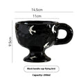 Hand-pinched irregular ceramic mug in a solid colour on a plain background.