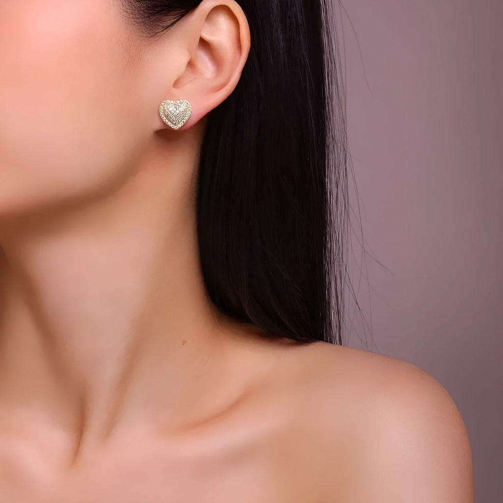 Golden heart-shaped stud earrings made from S925 silver with gold plating.