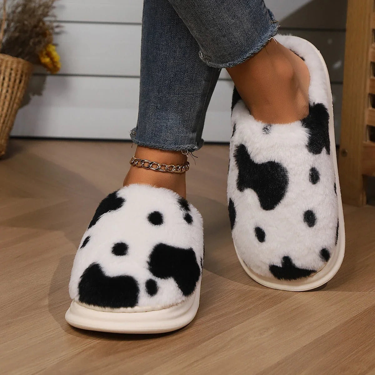 A pair of cozy, plush slippers with a unique spotted pattern, designed for warm and comfortable indoor wear.