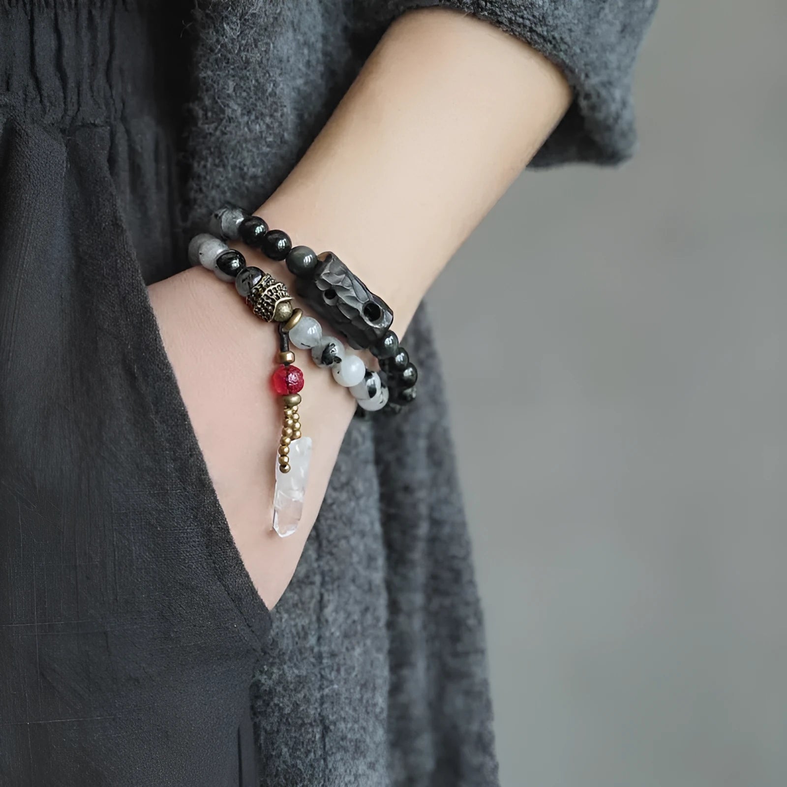 Ethnic style black hair bracelet with white crystal tassel showing bending and lacing construction details