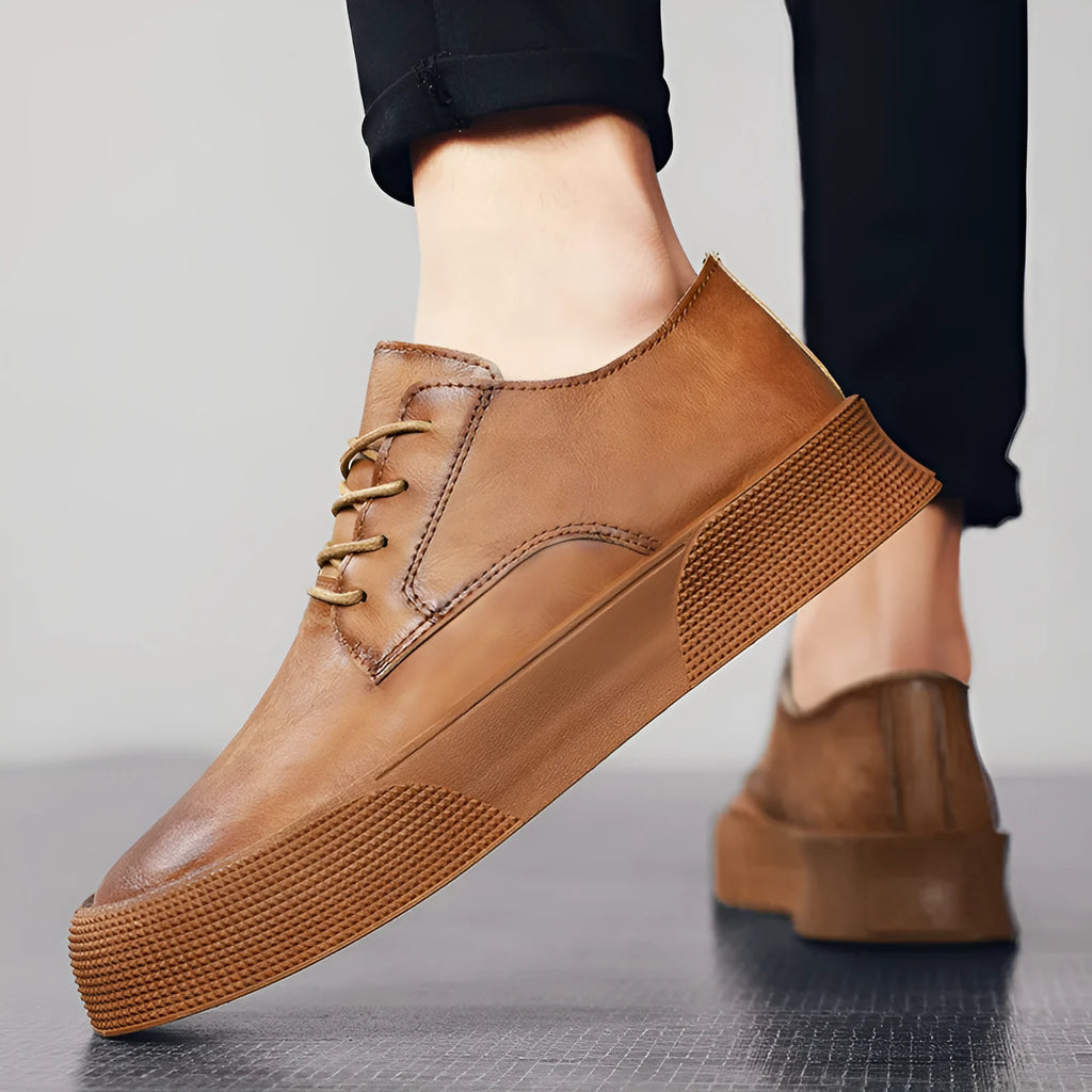 Men's lace-up platform board shoes in solid brown with round toe and low-top silhouette on a neutral background
