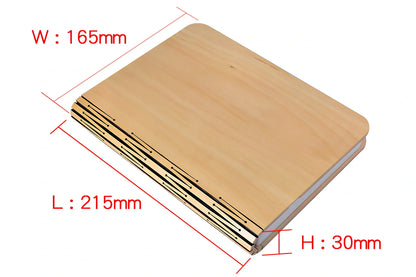 Wooden folding LED book light in walnut finish, open to 360 degrees showing warm white illumination on Tyvek pages, 21.5cm size