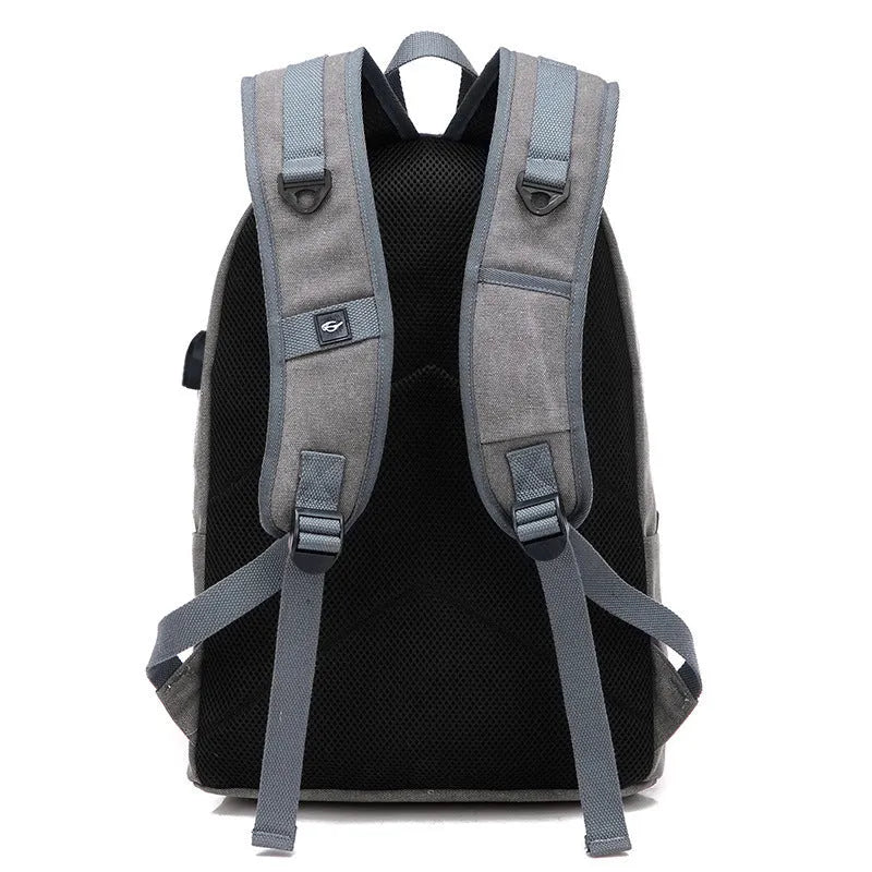 Canvas backpack with USB charging port in grey colour, showing front compartment and shoulder straps.