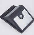 Set of four white rectangular solar-powered motion sensor lights for outdoor wall mounting.