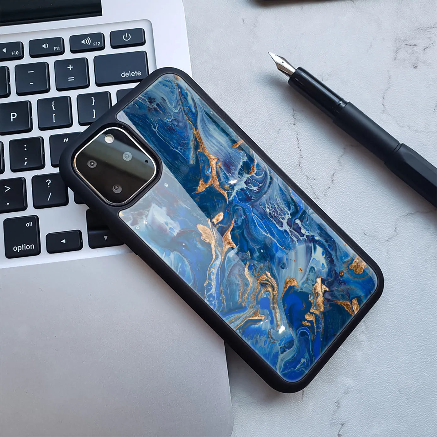 Marble effect plastic back cover iPhone case showing colour options including black gold and blue pink patterns