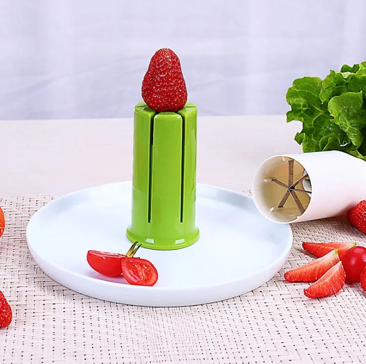 White kitchen vegetable slicer with six stainless steel blades for cucumbers and carrots.