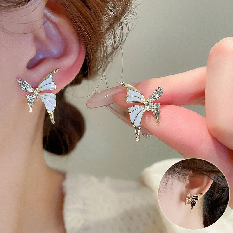 Rhinestone-dripped butterfly stud earrings in alloy with diamond treatment, available in colors A128 and A129