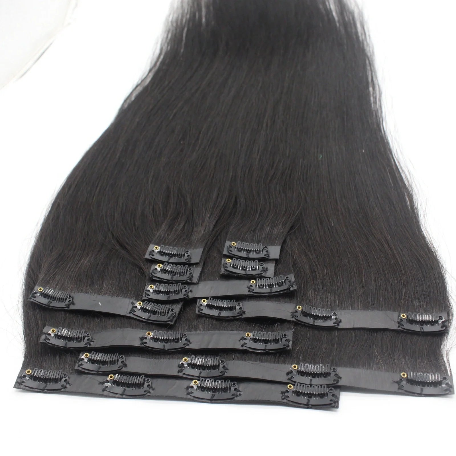 Clip-in human hair extensions in various lengths from 10 to 30 inches with secure attachment clips