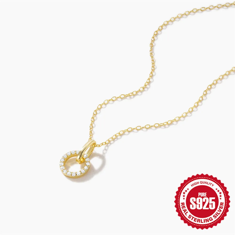 Gold geometric pendant necklace on a model, showing the interlocking design and adjustable clavicle chain.