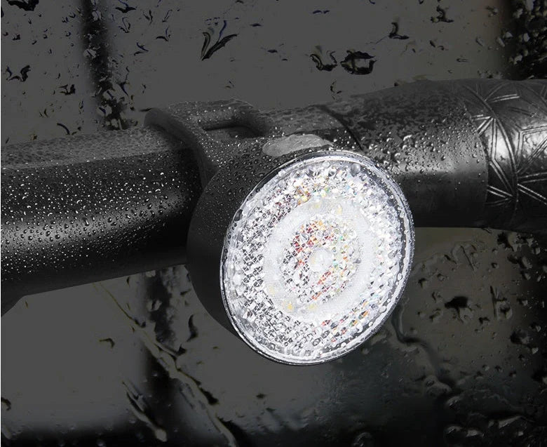 Bicycle LED headlight with clip attachment showing lens reflectors and USB port for charging