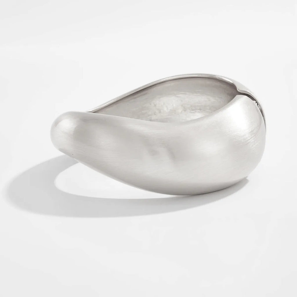 Metal alloy opening bracelet in matte or glossy finish with ellipse design element cold wind style