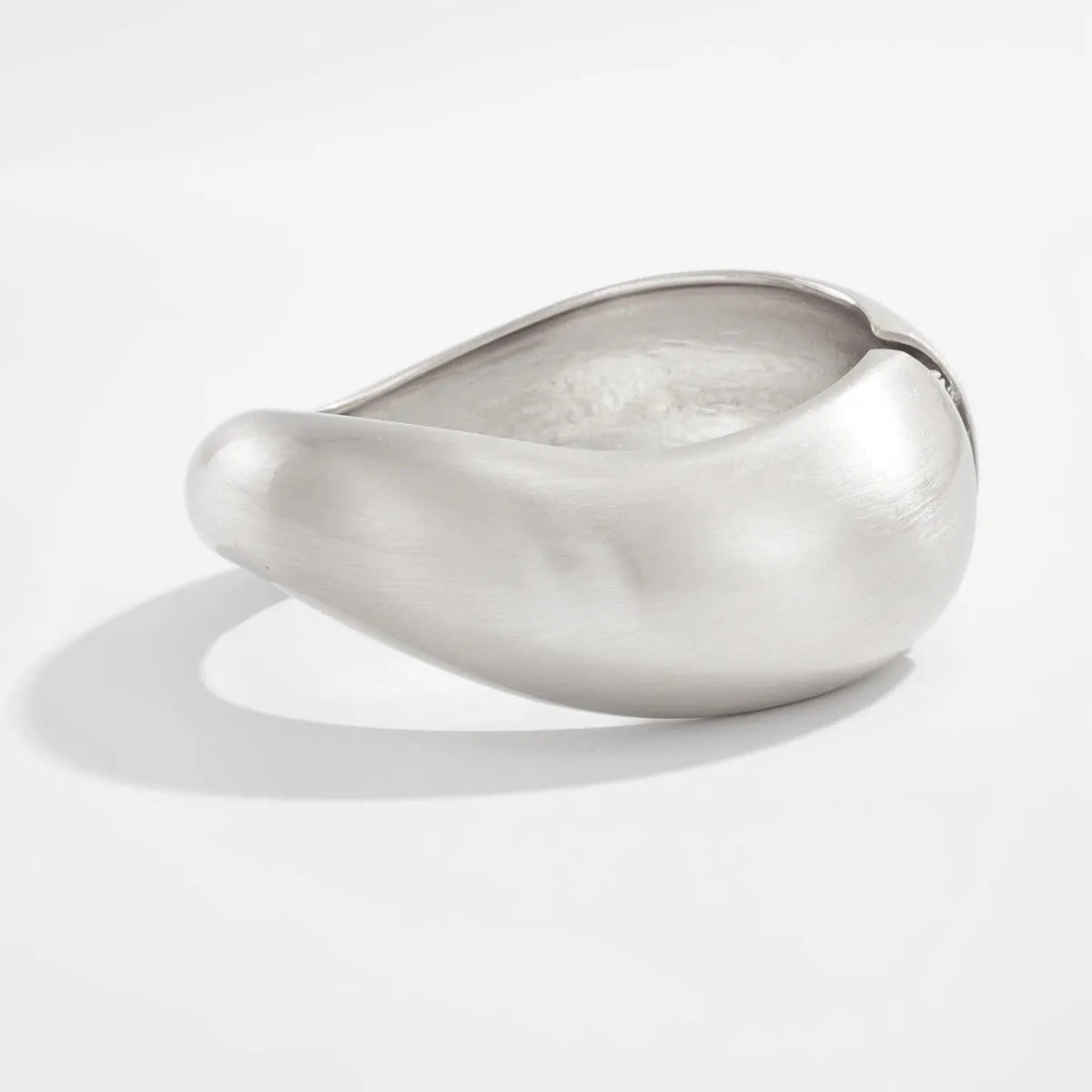 Metal alloy opening bracelet in matte or glossy finish with ellipse design element cold wind style