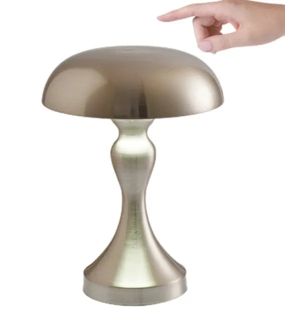 Metallic bronze LED desk lamp with touch control on a wooden desk next to a book.