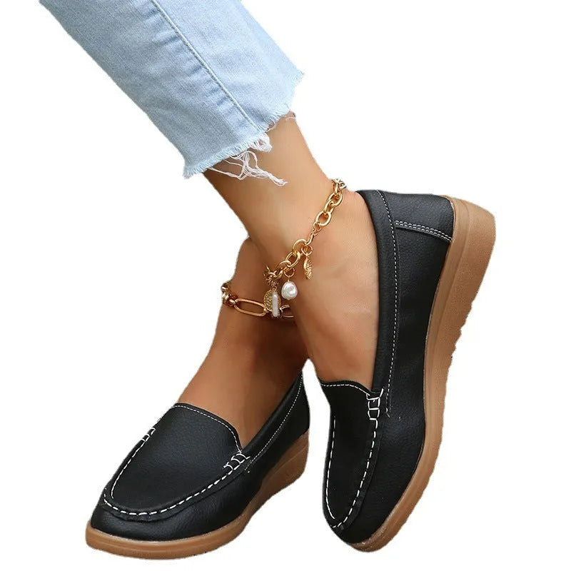 Women's black PU leather loafers with round toe and decorative car stitch detail on the upper.
