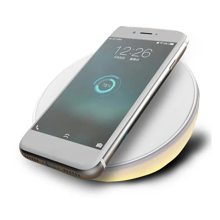 White wireless phone charger with LED digital clock display and three control buttons on the front.