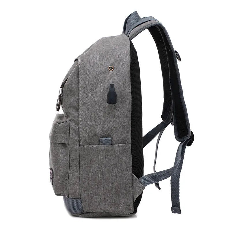 Canvas backpack with USB charging port in grey colour, showing front compartment and shoulder straps.