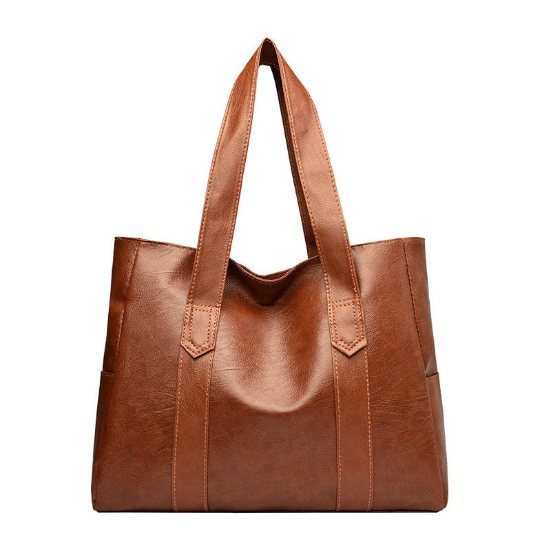 Large capacity commuter tote bag in brown and black with double shoulder straps and mobile phone pocket