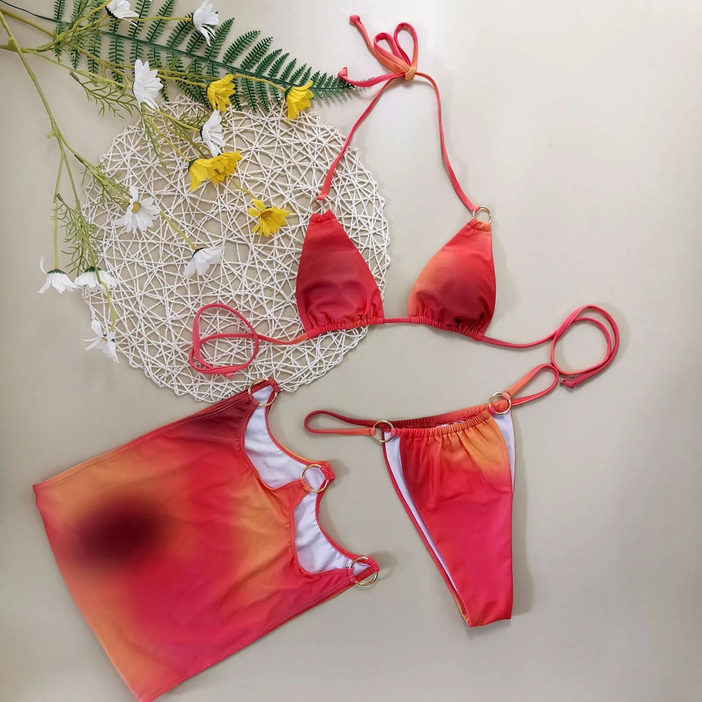 Tie-dye gradient three-piece halter bikini set on a mannequin, showing top, pants, and skirt.