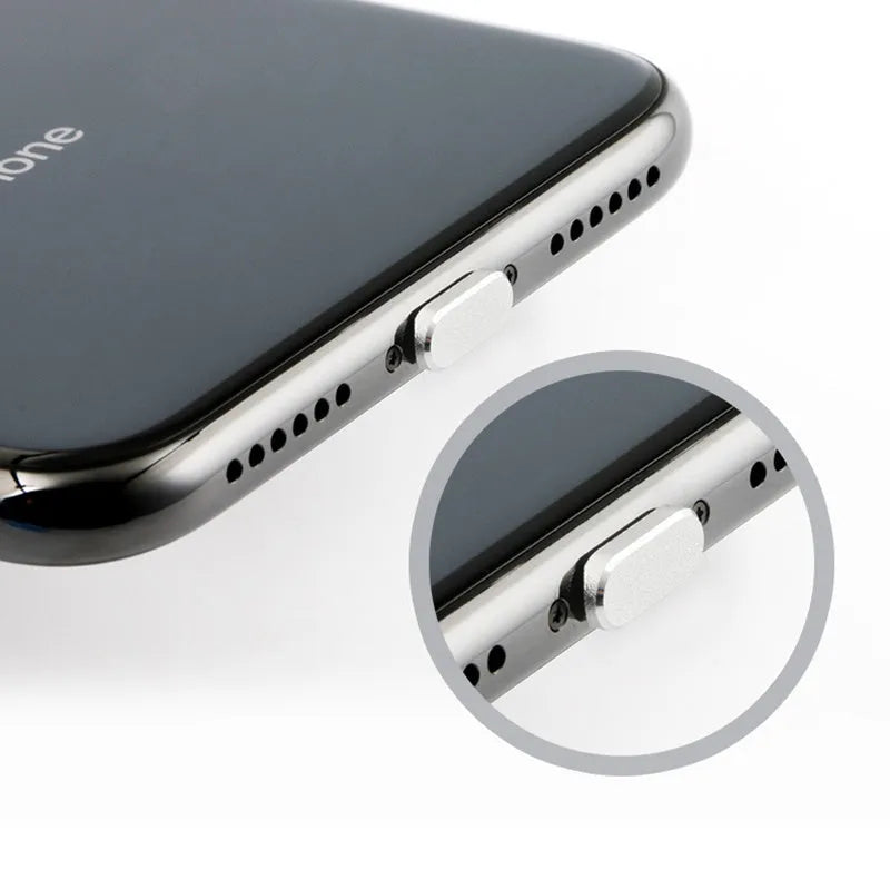 Aluminium alloy iPhone charging port dust plug in silver, shown next to an iPhone.