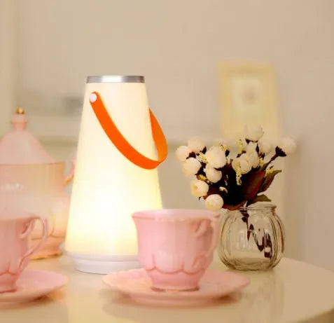 White rechargeable LED bedside lamp with warm light and adjustable brightness settings