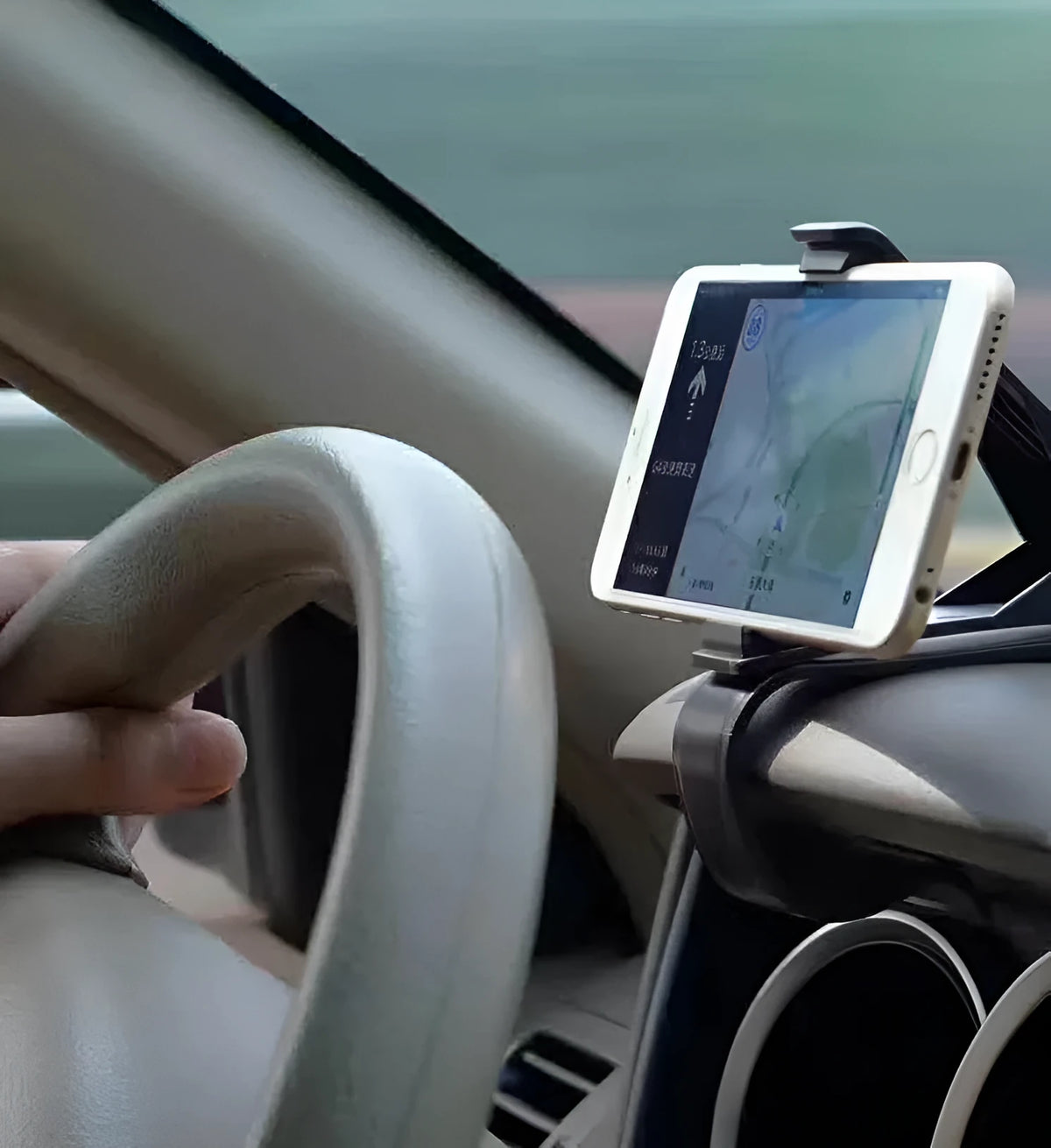 Black G-40 car bracket attached to steering wheel holding a mobile phone for navigation