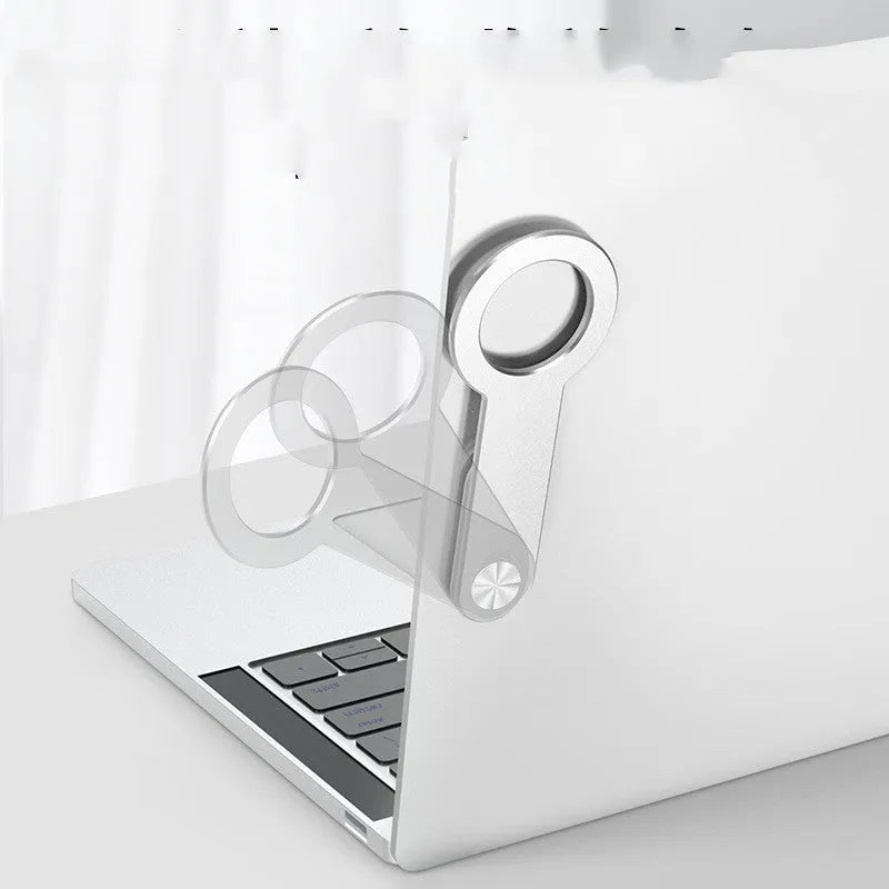 Silver aluminium alloy magnetic extension holder for mobile phones on a desktop.