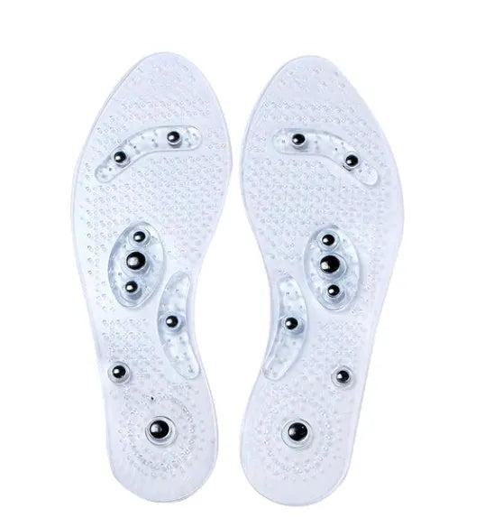 Transparent magnetic massage insole with silicone elastomer, visible magnets and massage nubs, on white background