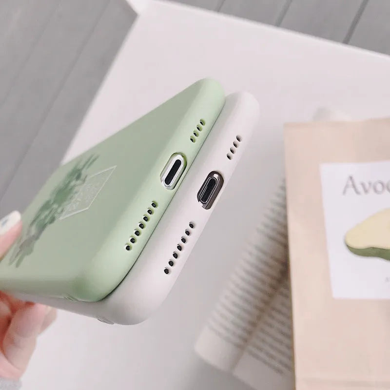 White silicone iPhone case with painted plant pattern design showing 360-degree edge protection