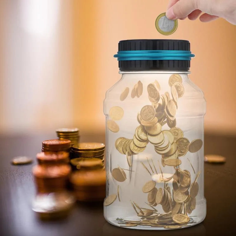 Transparent digital coin counting money box with LCD screen on lid, showing coin slot and clear jar body