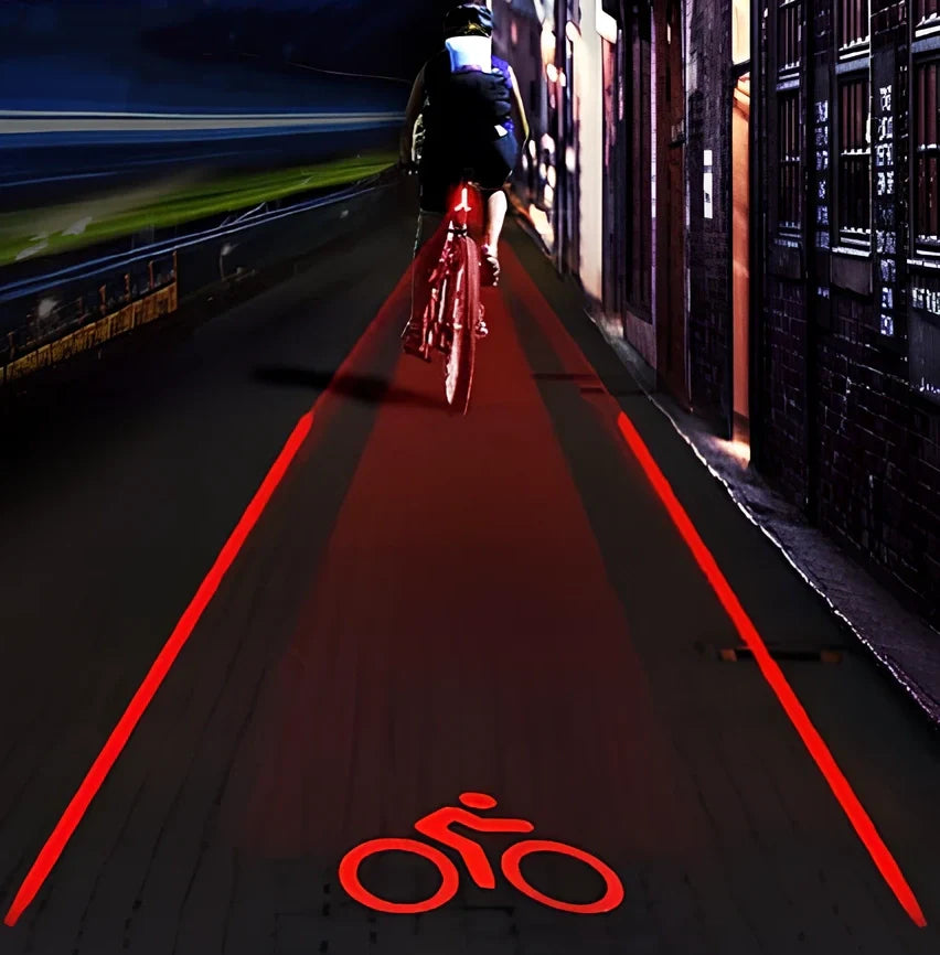 Black and red bicycle laser taillight with five LEDs and projection, 8.5x5x3.5 cm, mounted on bike frame