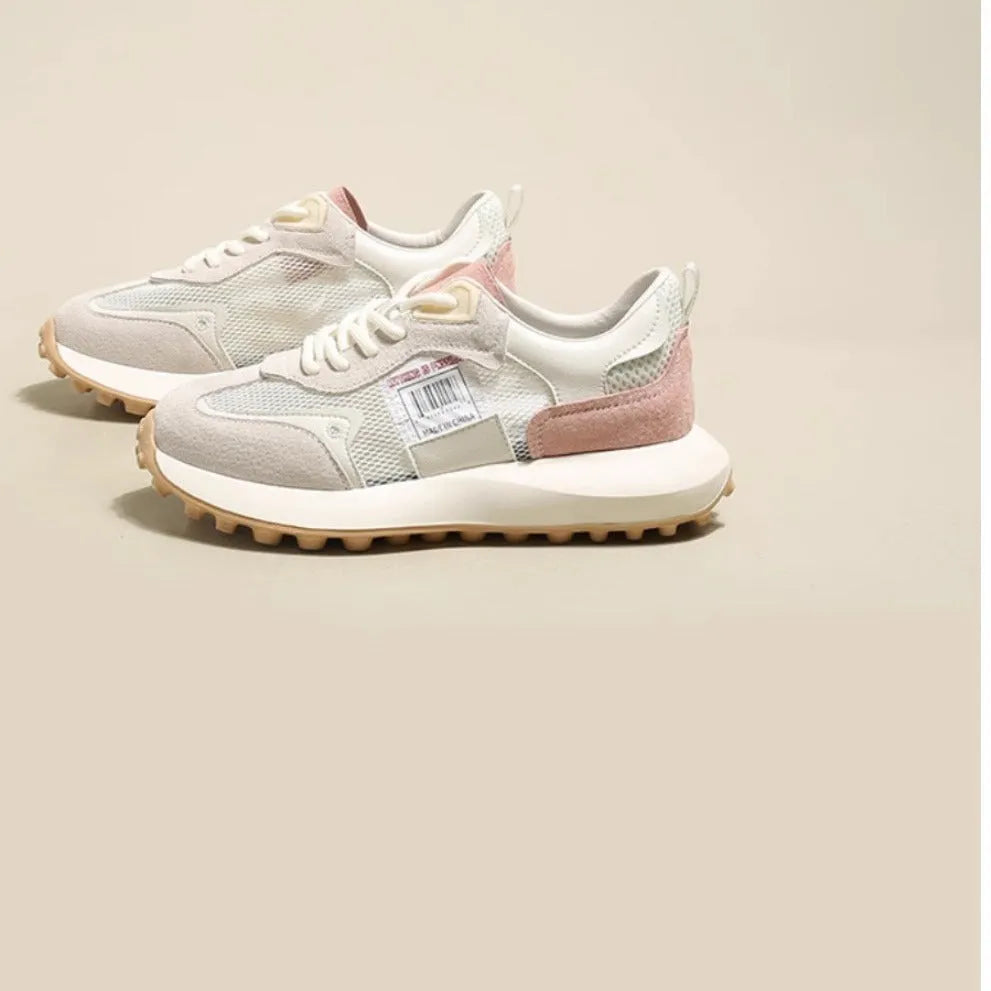 Women's low-top retro sneaker in grey or pink with round toe and rubber sole.