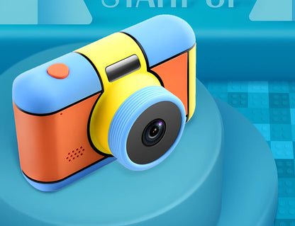 Children's 24MP digital camera in blue, showing 1080P video screen and 600mAh battery compartment, compact for small hands