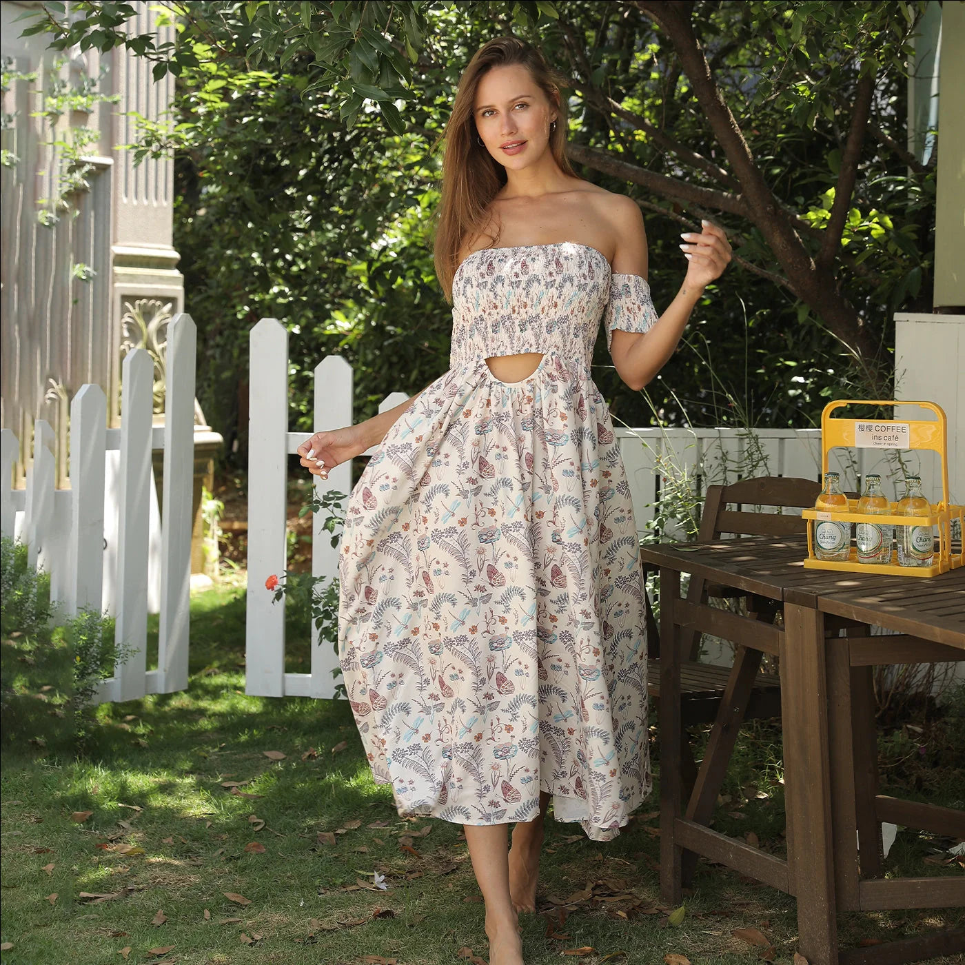 Women's off-shoulder strapless floral dress in a vibrant pattern, perfect for summer outings.